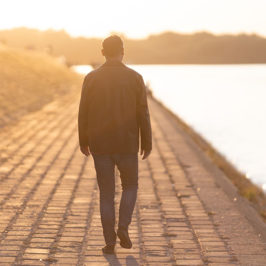 man walking mindfully through nature, reflecting emotional balance through Krishna's teachings