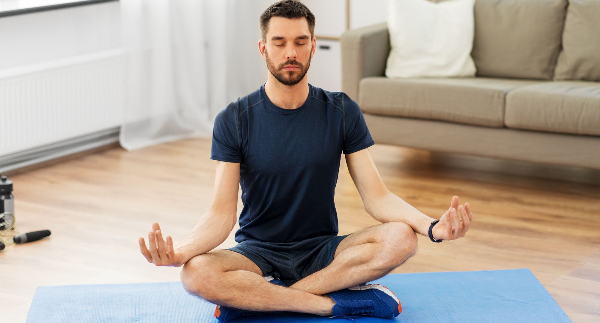 Young man practicing mindfulness meditation to find peace in a digital world